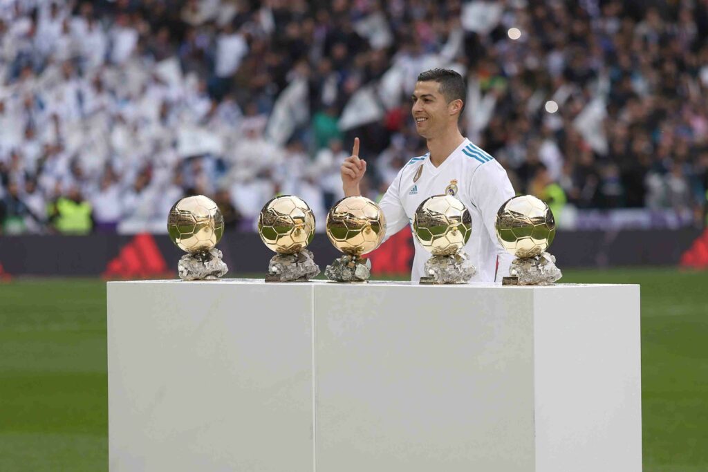 Cristiano RonaldoShocasing his Ballon d'Or awards at the Santiago Bernabéu Stadium