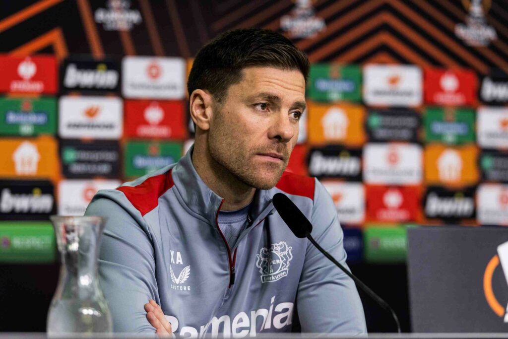 Xabi Alonso, coach of Bayer 04 Leverkusen, seated at the UEFA Europa League Round of 16 final press conference at BayArena Leverkusen on March 13, 2024, discussing the team's strategies and reflections on the match.